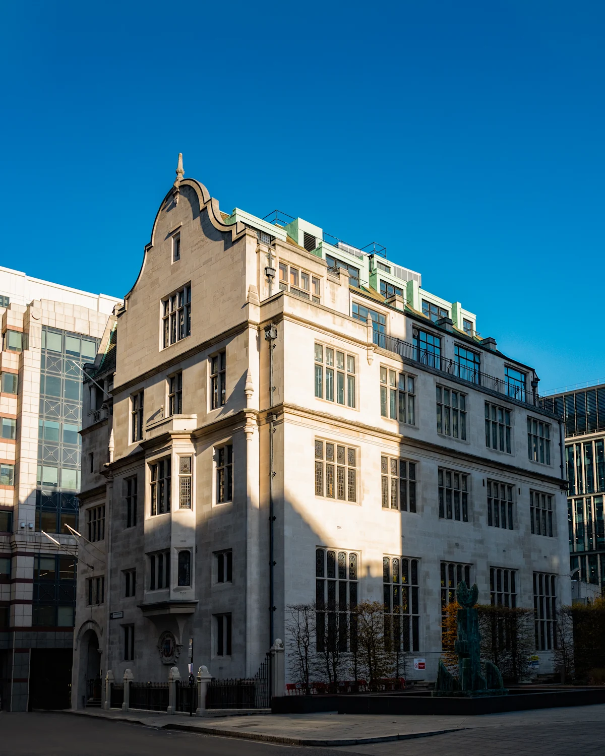 A historic building at Aldermanbury in London, showcasing classical architecture under a clear blue sky.