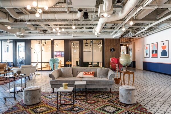 A modern, stylish office lounge area with colorful decor and eclectic furnishings at 9 Appold Street, London.