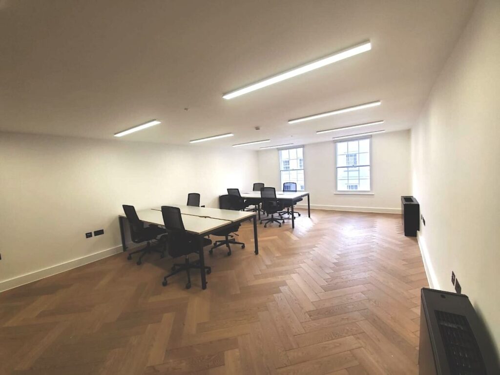 A modern office space with desks and chairs on Berwick Street, London.