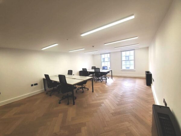 A modern office space with desks and chairs on Berwick Street, London.