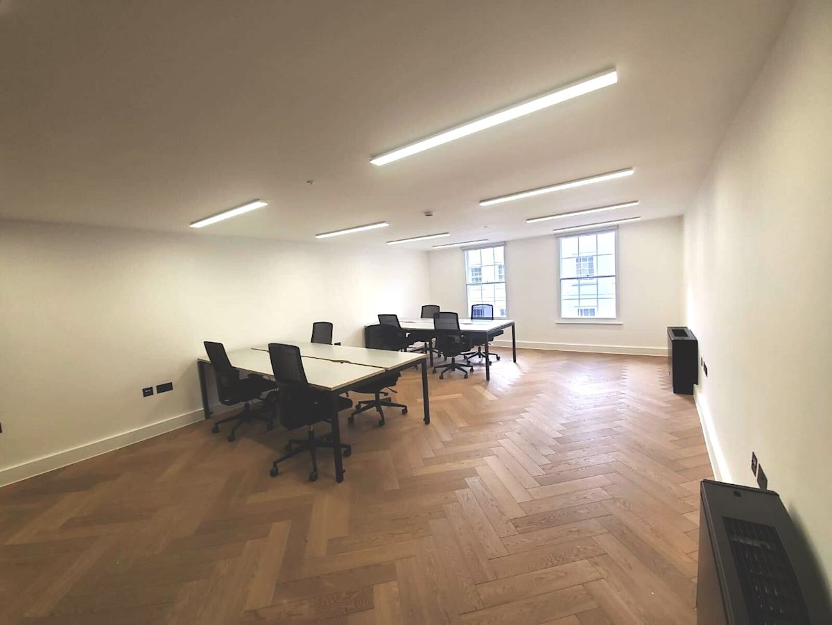 A modern office space with desks and chairs on Berwick Street, London.