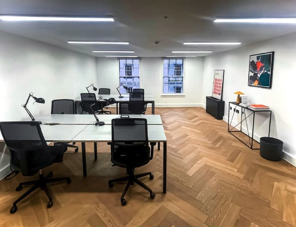 Modern office space at Berwick Street 30, London, featuring desks, chairs, and contemporary decor.
