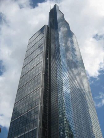 A tall, modern skyscraper located at Bishopsgate, London, set against a partly cloudy sky.