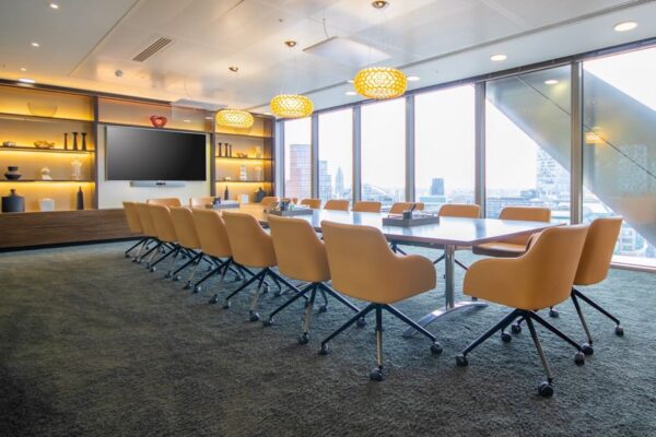 Modern conference room in Bishopsgate 110, London, with a large table and city views.