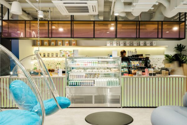 Modern café interior in Bishopsgate 199 London with hanging chairs and a stocked counter.