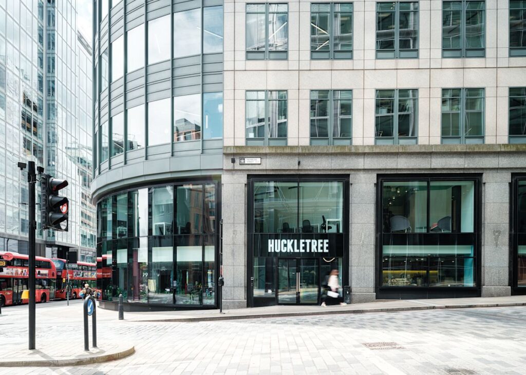 The modern facade of 199 Bishopsgate, featuring HuckleTree's entrance and large glass windows.