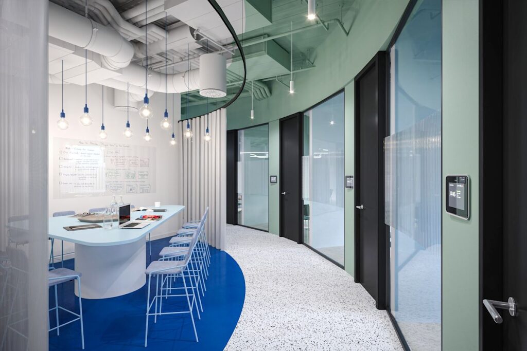 A modern conference room at Bishopsgate 199 London with a curved design and hanging light bulbs.