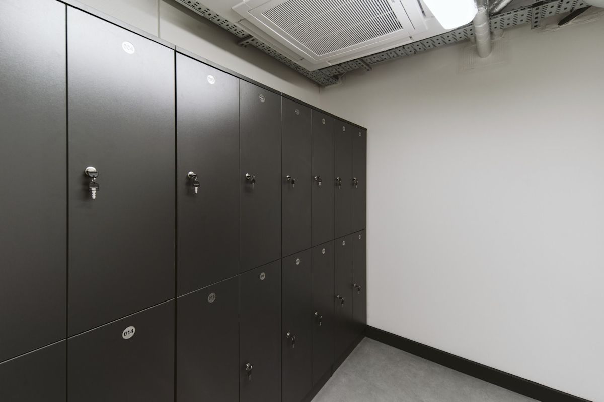A row of dark lockers inside a modern storage room.