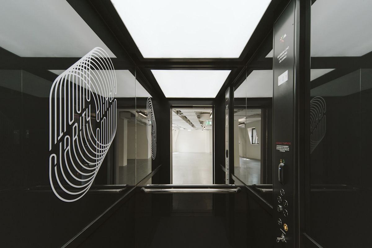 Interior view of a modern glass elevator in Bishopsgate 222 B, London.
