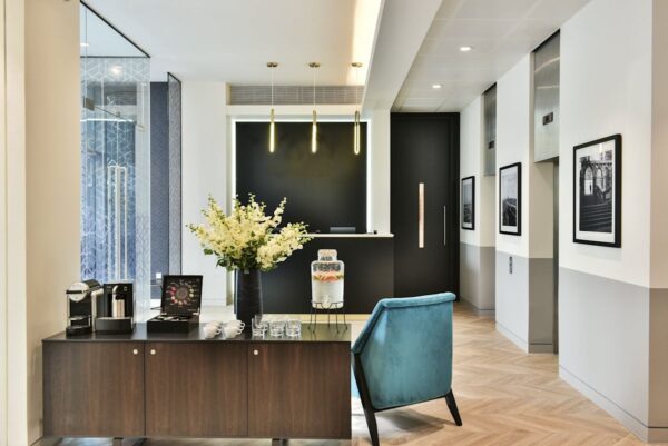 Modern office reception area at Bishopsgate 288 London with a coffee station and decorative plants.