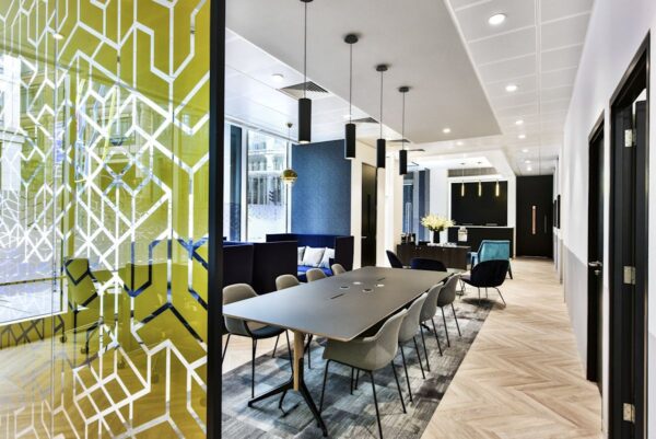 Modern office interior at Bishopsgate 288, London, featuring a stylish conference room with geometric glass partition and pendant lighting.