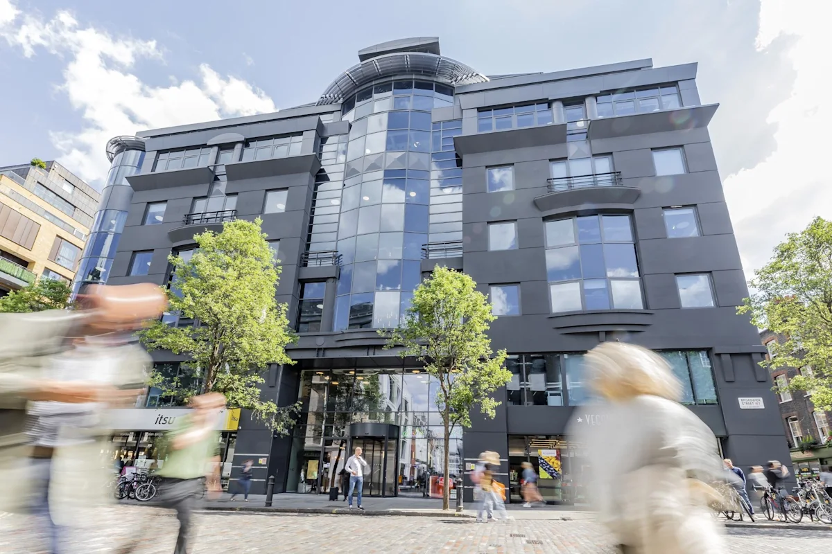Modern building on Broadwick Street in London, with pedestrians walking by.