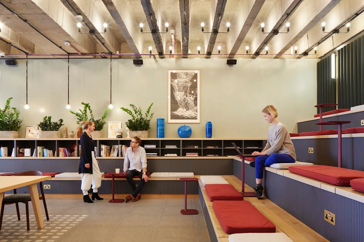 A modern, stylish coworking space with people interacting and working on laptops at Broadwick Street 33, London.