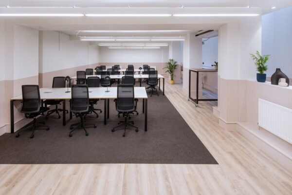 Modern office space with multiple desks and chairs on Broadwick Street, London.