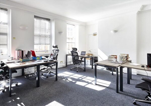 A bright, minimalist office space with desks, chairs, and office supplies at Broadwick Street 56-58, London.
