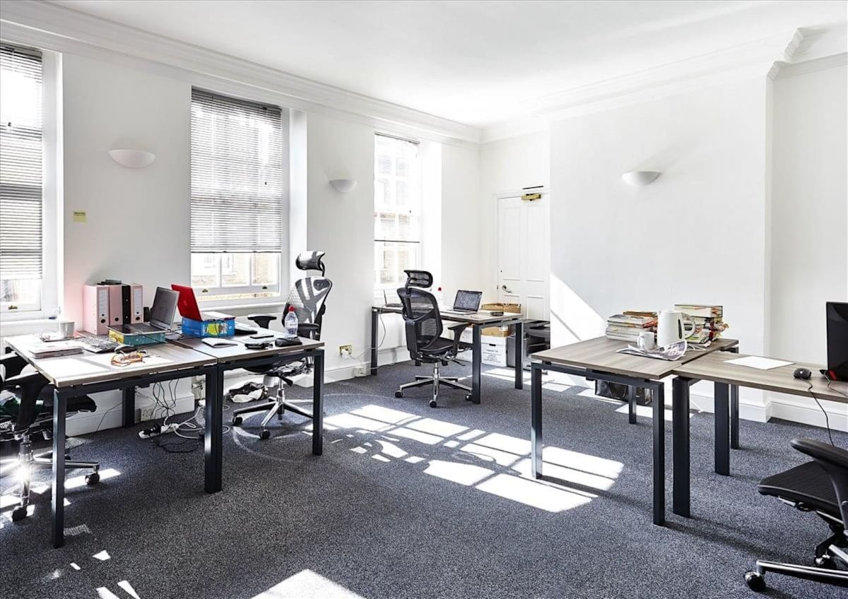 A bright, minimalist office space with desks, chairs, and office supplies at Broadwick Street 56-58, London.