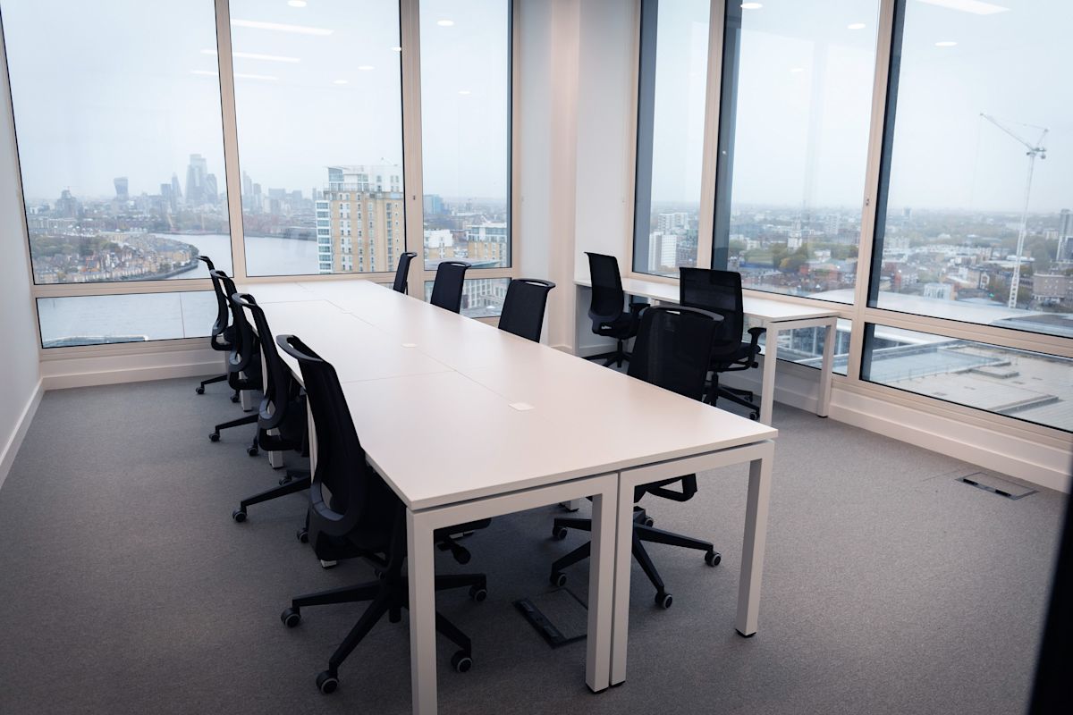 Modern office space with large windows offering a panoramic view of London from Cabot Square.