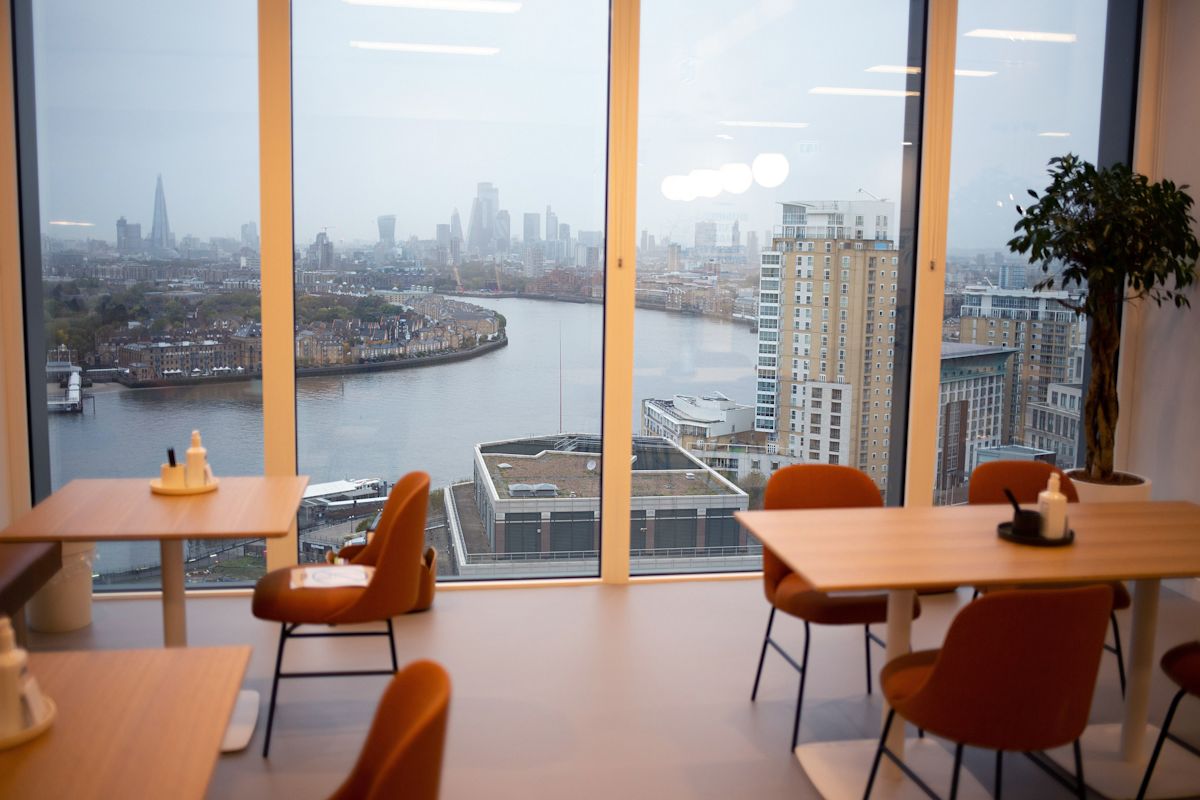 A modern office space with a panoramic view of the London skyline and the river.