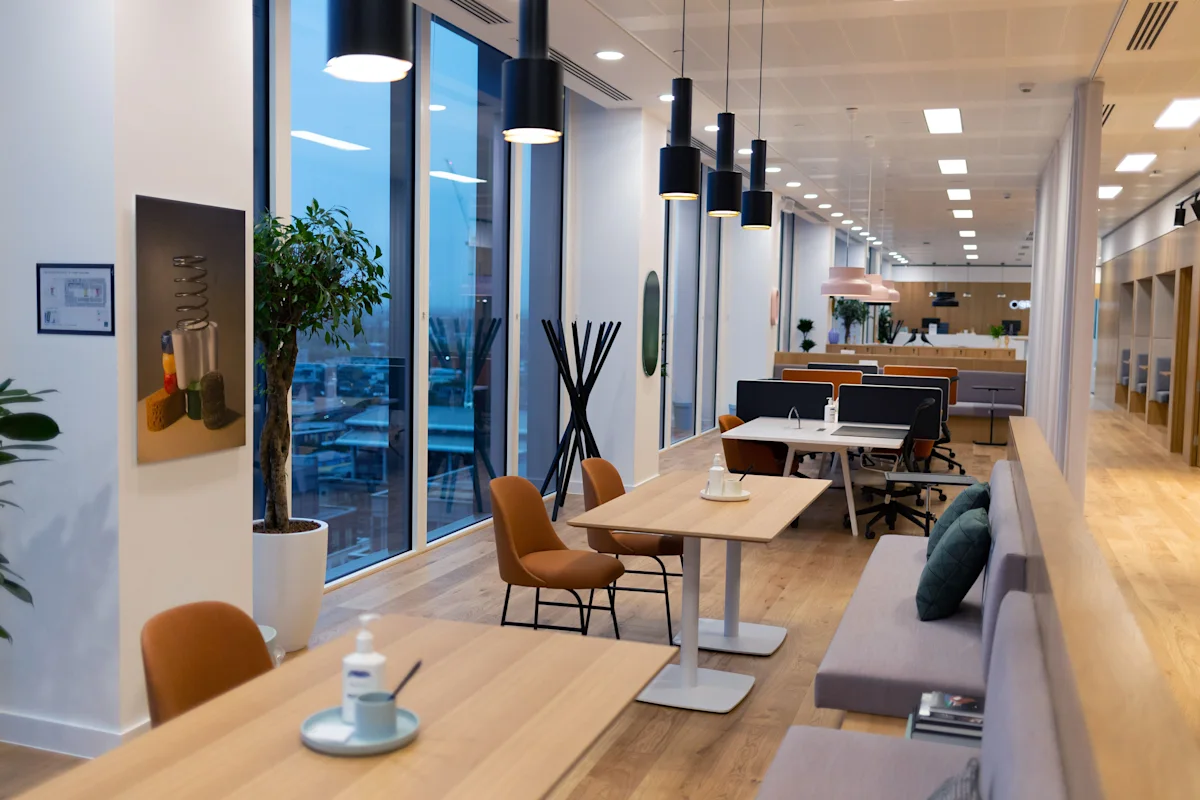 Modern office interior at Cabot Square 25, London, featuring open workspaces and large windows.