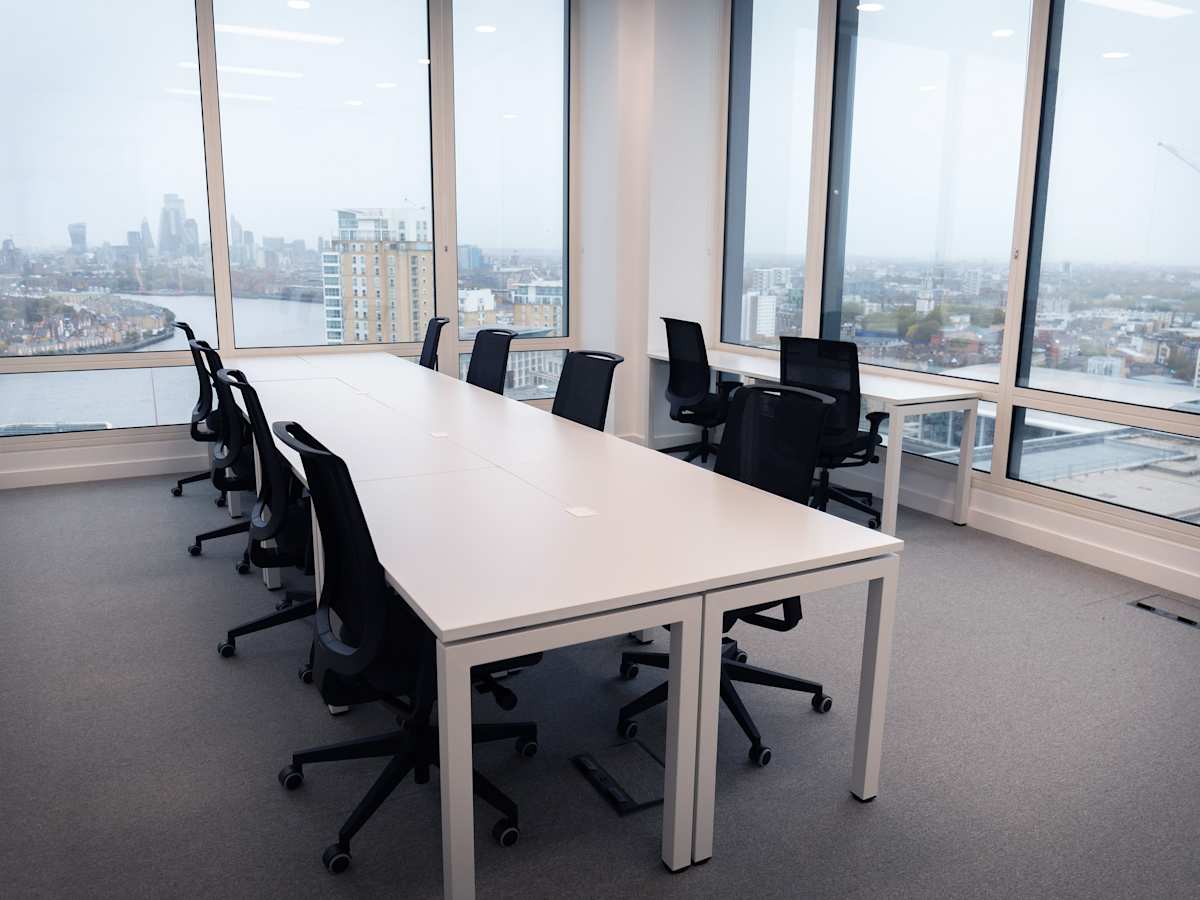 Modern office space with large windows offering a view of London from Cabot Square 25.