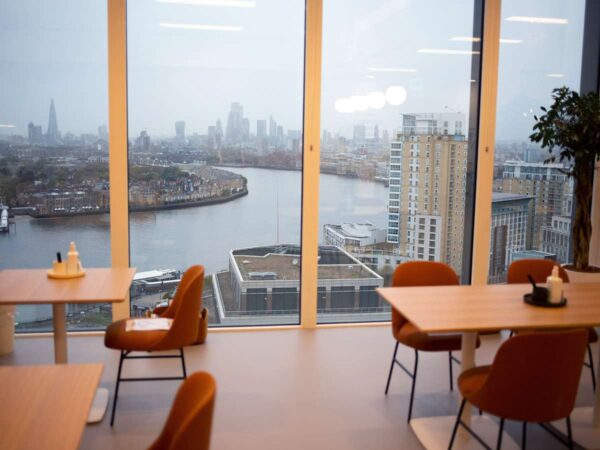 View from an office space in Cabot Square 25, London, overlooking the River Thames and city skyline.