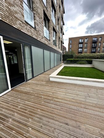 View of the patio and garden area on the first floor of Cadmus Court in London.