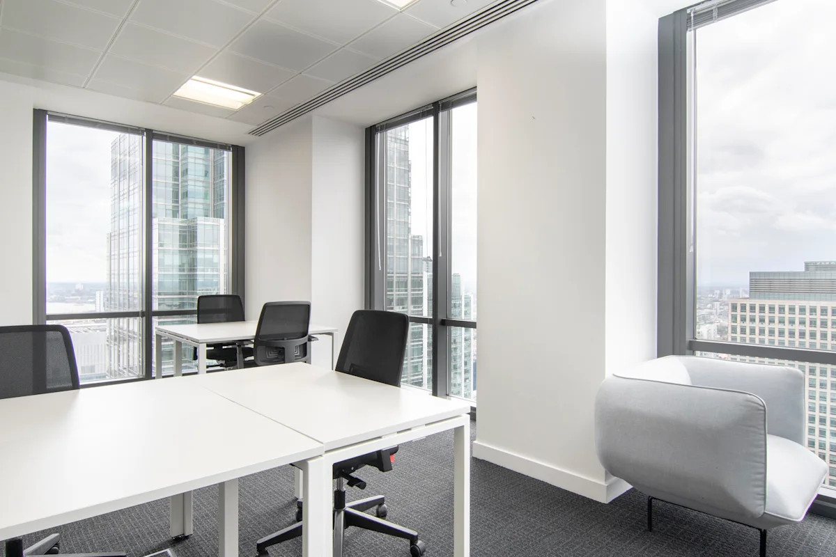 A modern office interior at Canada Square 1, London with large windows and office furniture.