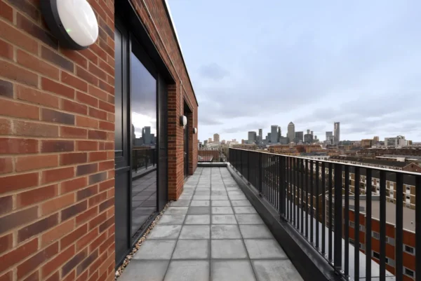 View of a modern balcony in London with a city skyline in the background.