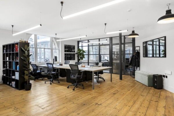 A modern, open-plan office space with wooden floors and large windows at Great Eastern Street 40, London.