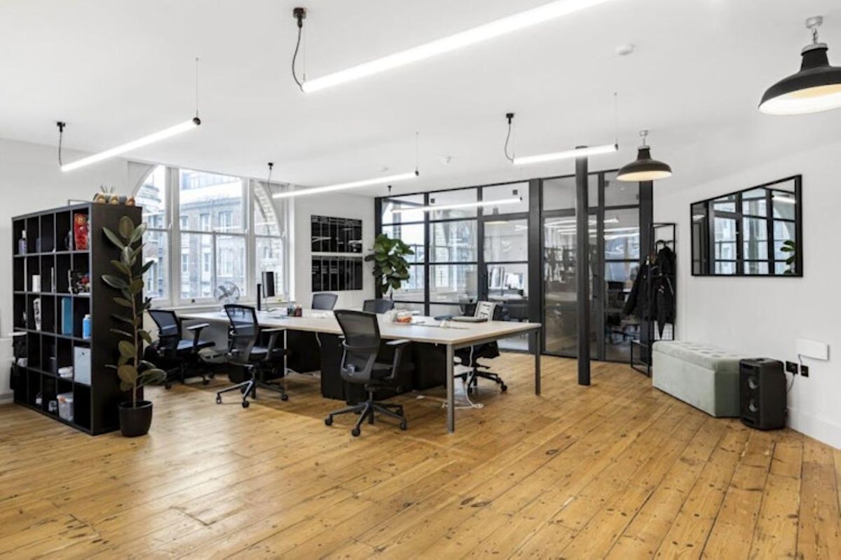 A modern, open-plan office space with wooden floors and large windows at Great Eastern Street 40, London.