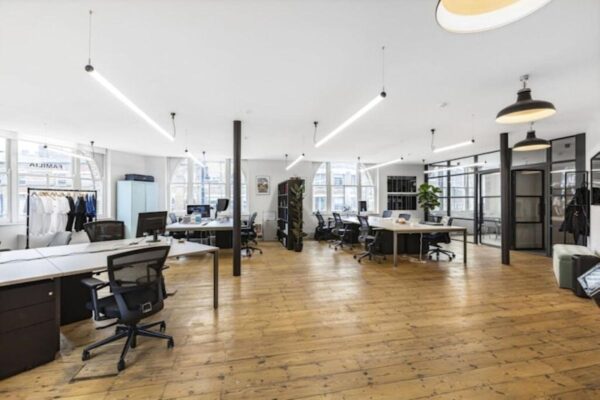 Modern open-plan office space with desks and wooden flooring at 40 Great Eastern Street, London.
