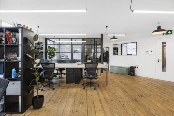 Modern office interior with wooden flooring and black office chairs at 40 Great Eastern Street, London.