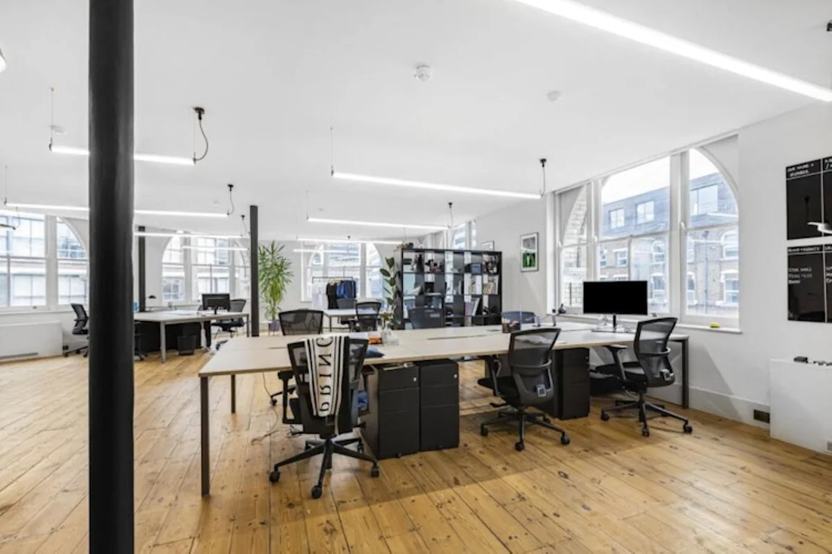 Modern open-plan office space with desks, chairs, and large windows at 40 Great Eastern Street, London.