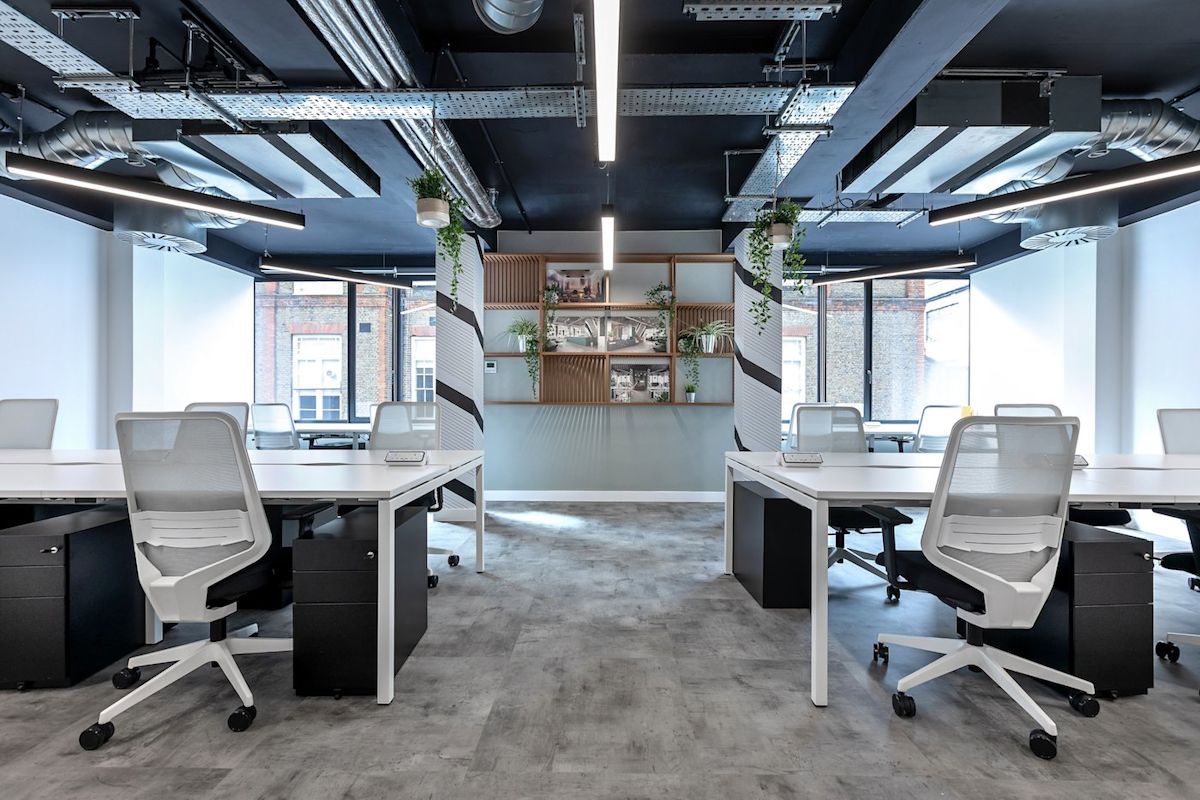 Modern office space with white desks and chairs at Ingestre Place, London.