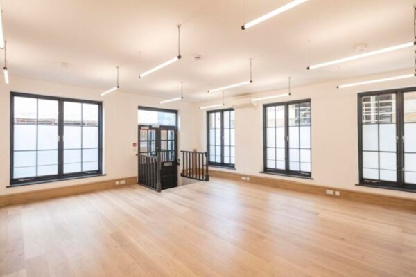 Bright, modern office space with large windows and wooden flooring at Luke Street 78a, London.
