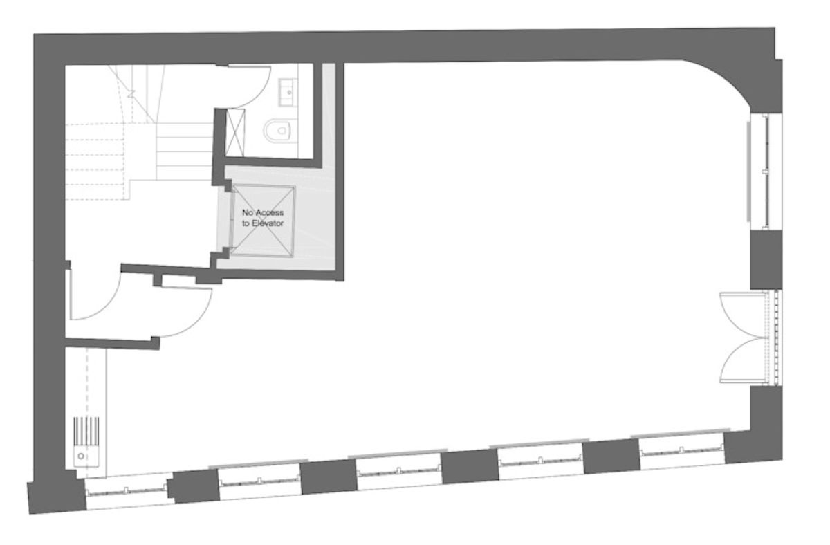Floor plan of a building at Luke Street 78a, London, showing a large open space, a stairway, a restroom, and a noted restricted access to an elevator.