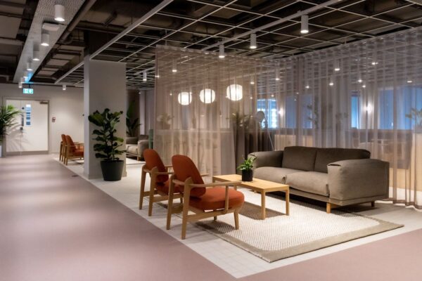 Modern office lounge area with comfortable seating and soft lighting at Marsh Wall 77, London.