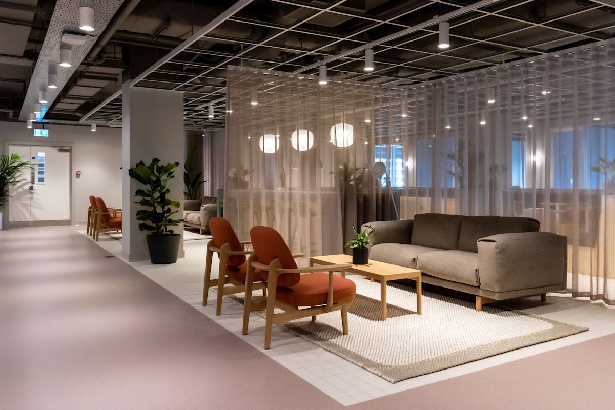 Modern office lounge area with comfortable seating and soft lighting at Marsh Wall 77, London.