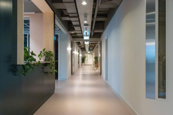 A modern hallway in Marsh Wall 77, London, featuring plants and sleek design elements.