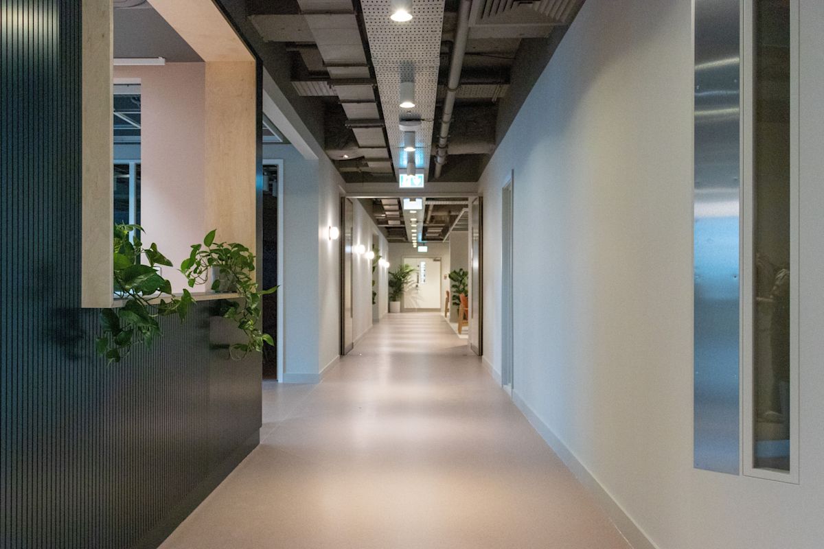 A modern hallway in Marsh Wall 77, London, featuring plants and sleek design elements.