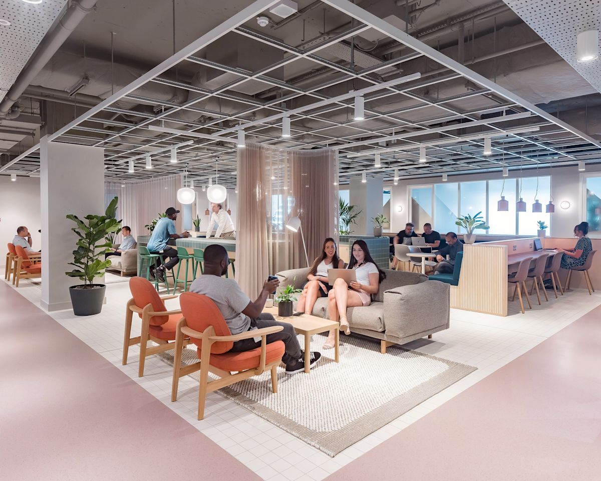 A modern and spacious co-working area at Marsh Wall 77 London with people seated and collaborating.