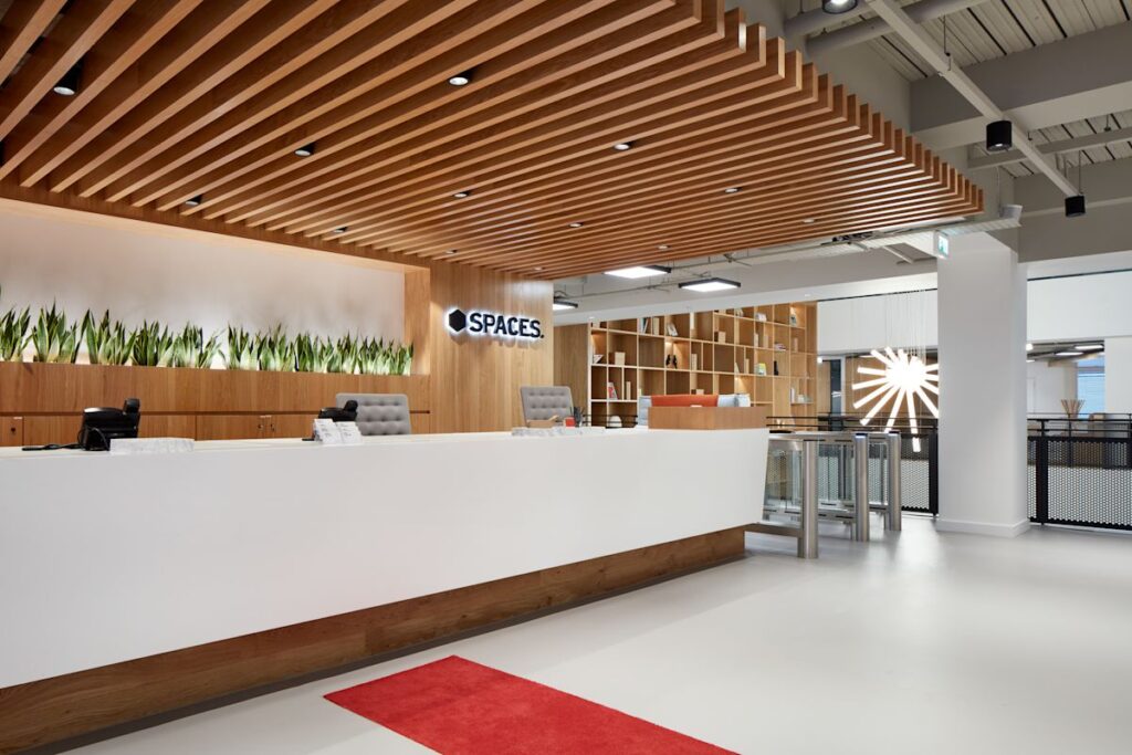 Modern reception area at Spaces office on New Broad Street 35, London, featuring a wooden ceiling and sleek interior design.