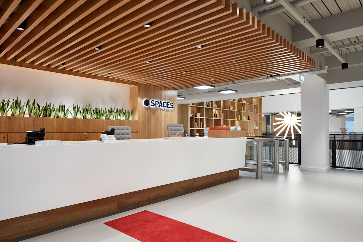 Modern reception area at Spaces office on New Broad Street 35, London, featuring a wooden ceiling and sleek interior design.