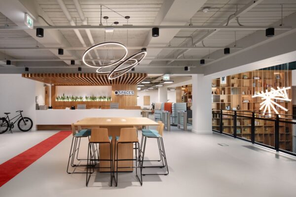 Modern office interior with wooden furniture and decorative lighting at Spaces, New Broad Street 35, London.