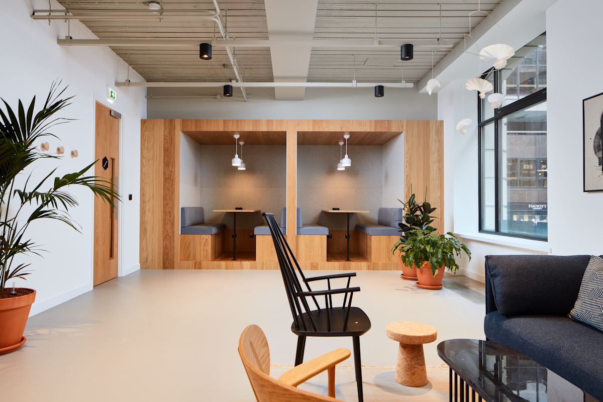 Modern office space with wooden booth seating and contemporary furniture at 35 New Broad Street, London.