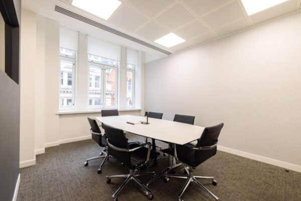 A modern conference room with a rectangular table and six chairs at 42 New Broad Street, London.