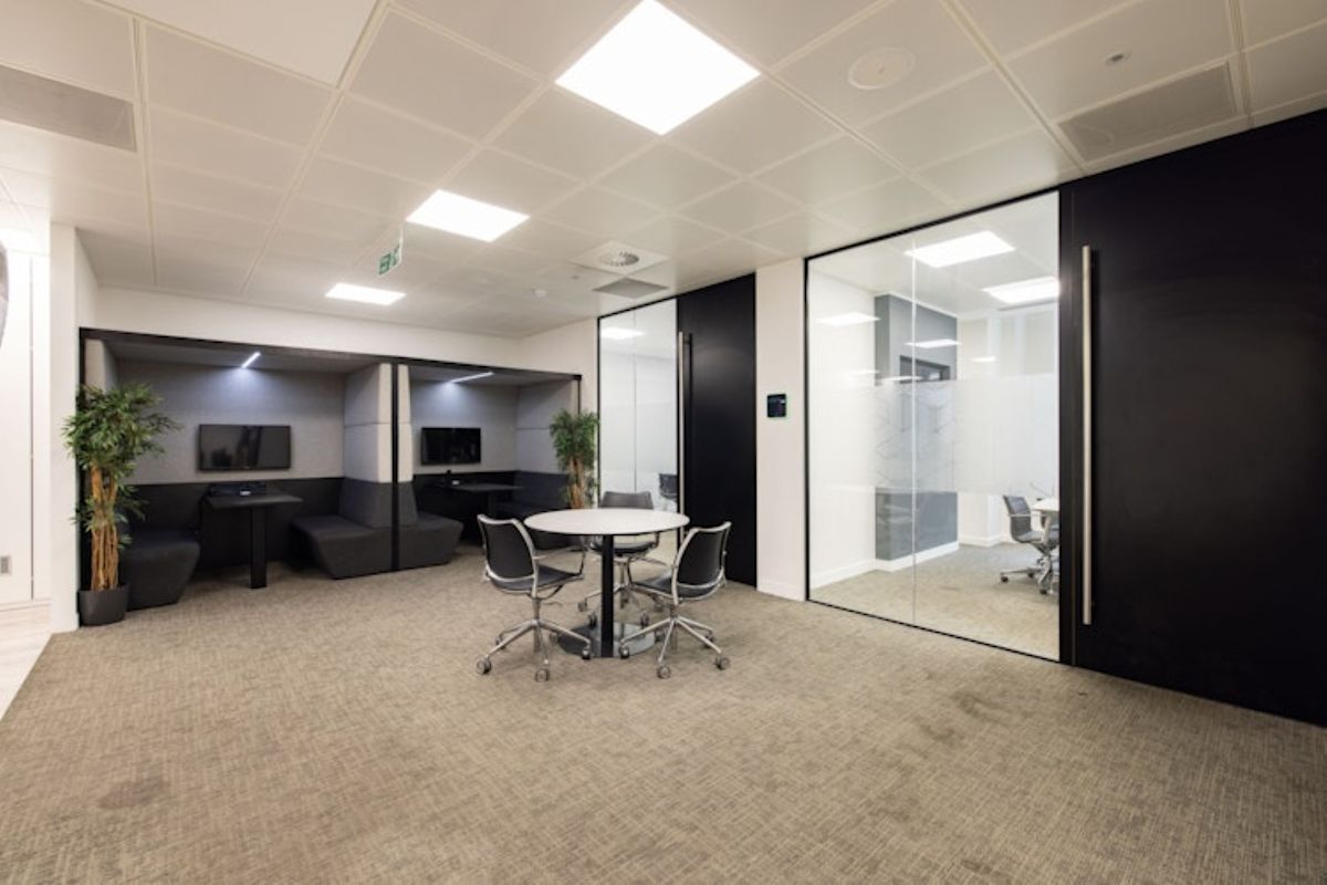 Modern office space with meeting areas and glass partitions at 42 New Broad Street, London.