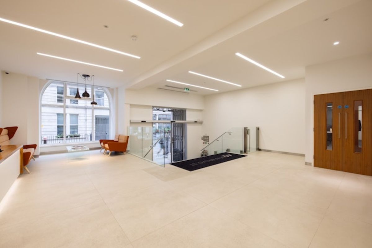 Modern lobby interior at 42 New Broad Street, London with seating and glass doors.