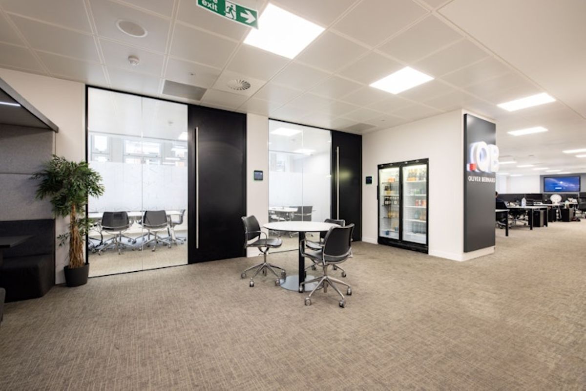 Modern office interior with meeting area and glass-walled conference room at 42 New Broad Street, London.