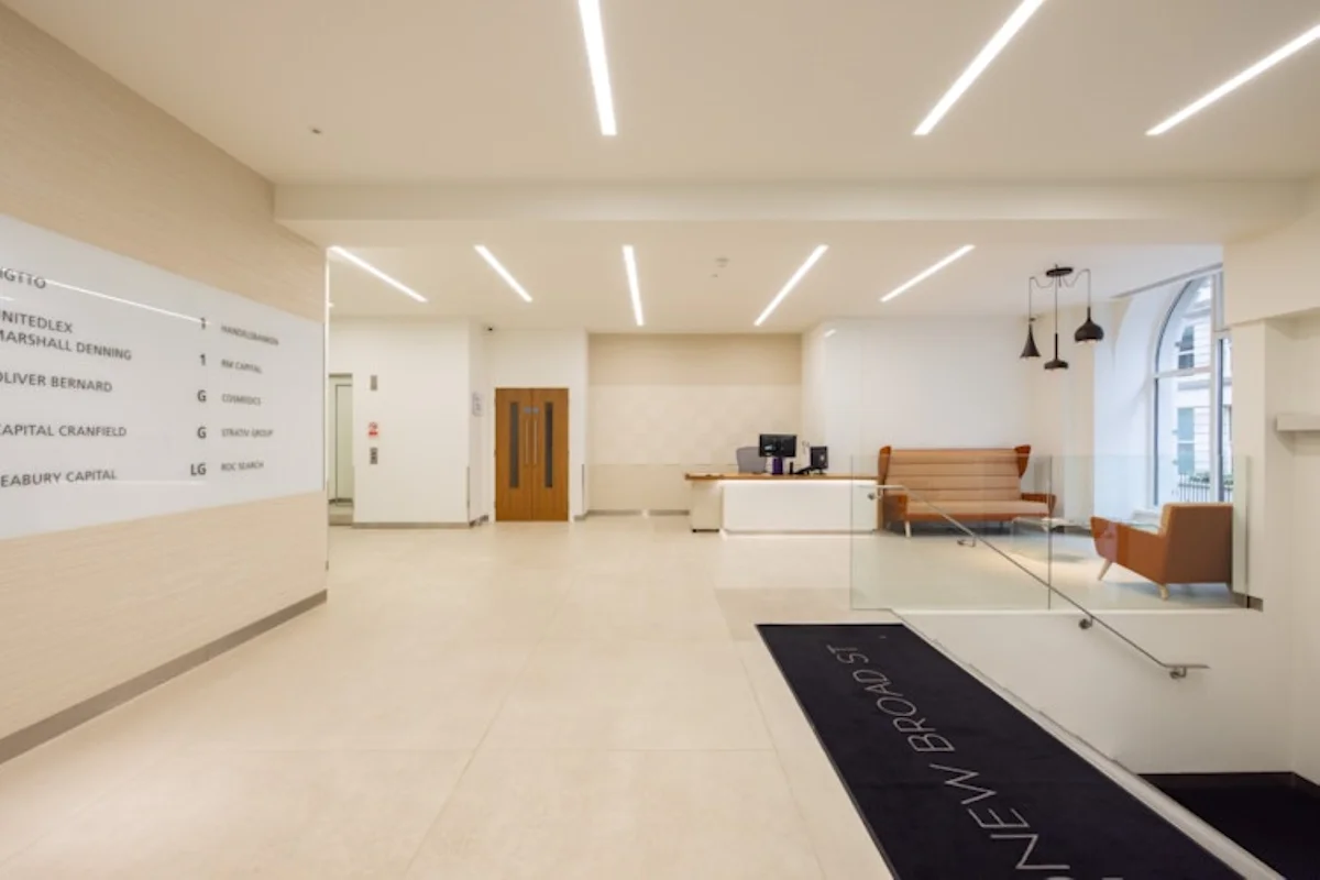 Modern office lobby at 42 New Broad Street, London, featuring a reception desk and seating area.
